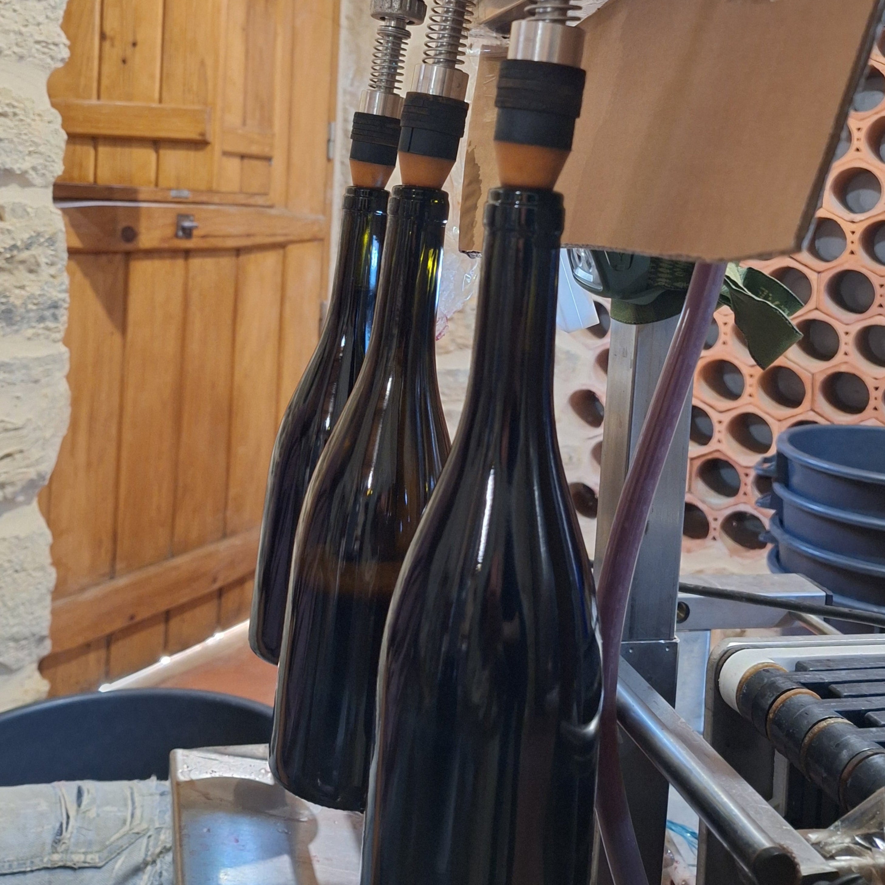 Wine bottles being filled during the bottling process at Casa Navarro Cordeiro winery